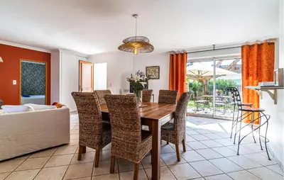 a dining room with a table and chairs and a couch at 2 Bedroom Amazing Home In Noves in Noves