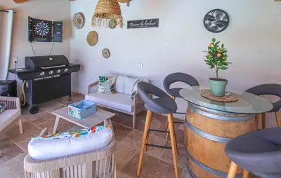 a living room with a table and a stove at Villa Contemporaine Provençale in Mormoiron