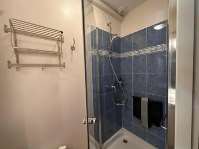 a bathroom with a shower with blue tiles at Villa Nicole avec piscine & jardin privés, parking dans le cœur du Luberon, proche Gordes, Roussillon, Goult, Bonnieux in Oppède