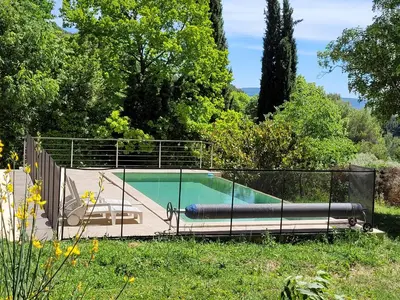 a swimming pool with a fence around it at Gîte Chrysalide du Luberon in Cheval-Blanc