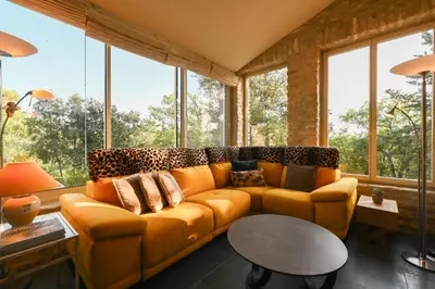a living room with a couch and a table at Le MAS DES VERGIERS in Murs