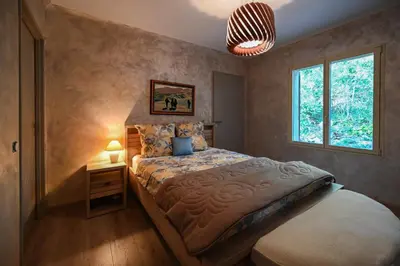 a bedroom with a bed and a window at Le MAS DES VERGIERS in Murs
