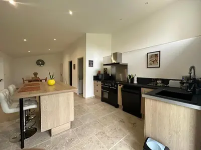 a kitchen with black appliances and a counter top at Gite le pèlerin in Sault-de-Vaucluse