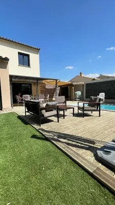a backyard with two benches and a swimming pool at Entre Vignes et Ventoux 3 chambres 6 à 8 pers in Malemort-du-Comtat