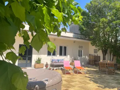 a patio with chairs and a couch in front of a house at Les Lavandières in Velleron