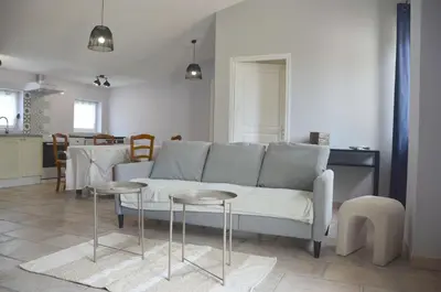 a living room with a couch and two tables at Les Lavandières in Velleron