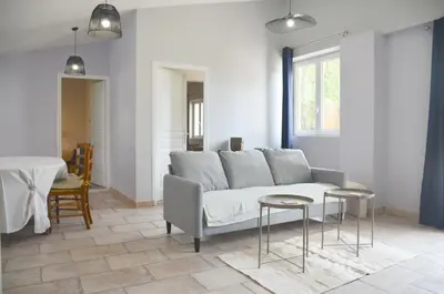 a living room with a couch and a table at Les Lavandières in Velleron