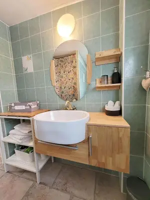 a bathroom with a white sink and a mirror at Les Lavandières in Velleron