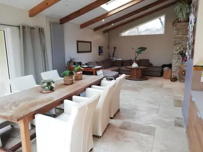 a dining room with a wooden table and white chairs at country house in Provence in Pierrevert