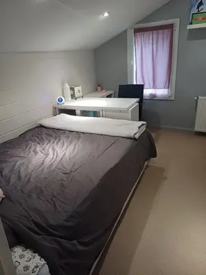 a bedroom with a large bed and a desk at country house in Provence in Pierrevert