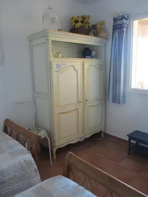 a yellow cabinet in a room with a window at Appartement les Balcons d'Azur in Vernègues