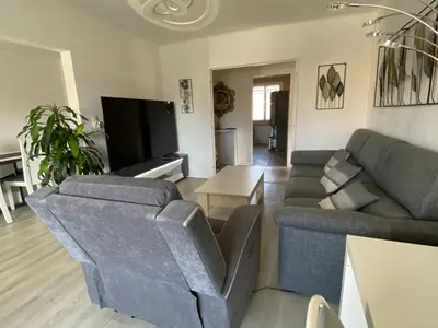 a living room with a couch and a table at Grand appartement spacieux in Sénas