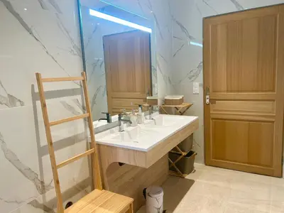 a bathroom with a sink and a mirror at Évasion Ventoux, villa spacieuse et accessible PMR in Carpentras