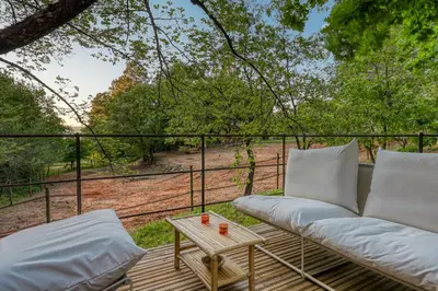 a patio with a couch and a table at Tipi à Roussillon in Roussillon