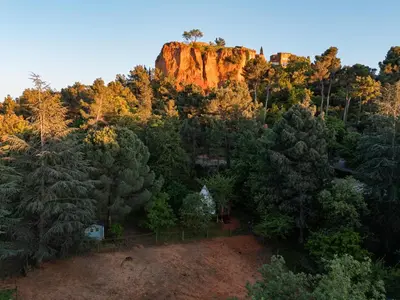 an aerial view of a rocky mountain with trees at Tipi à Roussillon in Roussillon