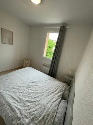 a small bedroom with a bed and a window at Maison aux Demeures du Ventoux in Aubignan