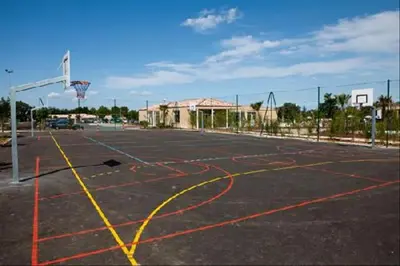 an empty basketball court with a basketball hoop at Maison aux Demeures du Ventoux in Aubignan