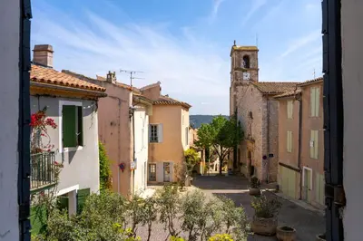 an alley in an old town with a tower at L’oustaou de Ventabren Village Square in Ventabren