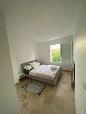 a bedroom with a bed and a window at La Maison Myssa in Apt