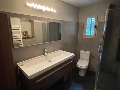 a bathroom with a sink and a toilet and a mirror at Maison Cireline en Provence, Rognes in Rognes
