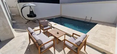 a swimming pool with chairs and a table at Quiet, discreet places in Vernègues