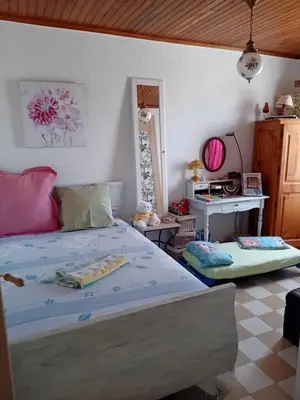 a bedroom with a bed and a desk in it at T3 campagne d'Aix-en-Provence in Meyrargues