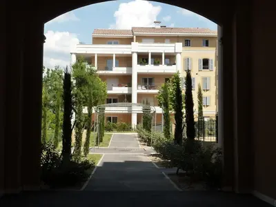 a view of a building from an archway at Appartement calme et spacieux à Aix en Provence in Aix-en-Provence