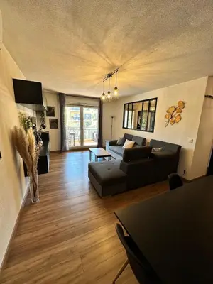 a living room with a couch and a table at Appartement calme et spacieux à Aix en Provence in Aix-en-Provence
