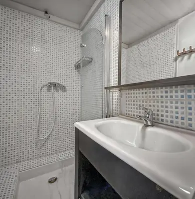a white bathroom with a sink and a shower at T2 charmant avec mezzanine au cœur d'Aix in Aix-en-Provence