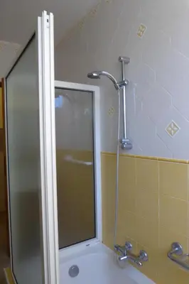 a shower with a glass door in a bathroom at Maison en PROVENCE in Robion en Luberon