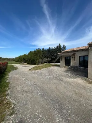 a dirt road next to a house with trees at Charmante maison avec piscine et grand jardin in LʼIsle-sur-la-Sorgue