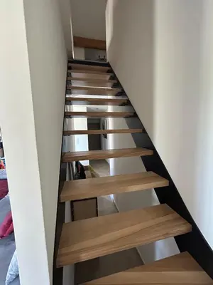 a staircase in a house with wooden steps at Charmante maison avec piscine et grand jardin in LʼIsle-sur-la-Sorgue