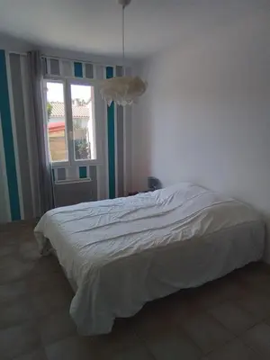 a bedroom with a white bed with a window at Ventoux beautiful quiet house in Saint-Christol