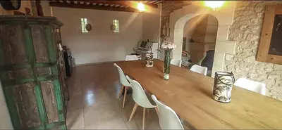 a wooden table with white chairs and vases on it at Charming house Saint Remy de Provence in Saint-Rémy-de-Provence
