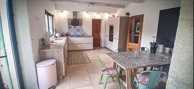 a kitchen with a table and chairs in a room at Charming house Saint Remy de Provence in Saint-Rémy-de-Provence