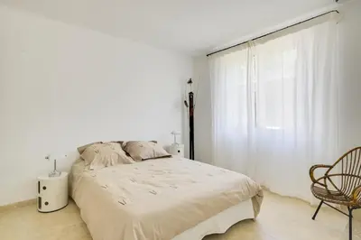 a white bedroom with a bed and a window at Villa Cali - Air-conditioned, Pool, Heart Village in Cabrières-dʼAvignon