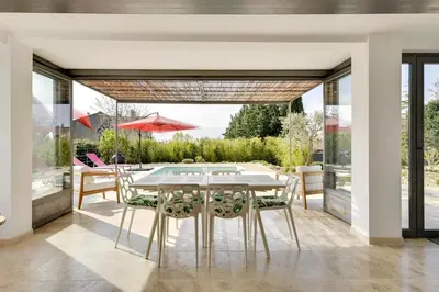 a dining room with a table and chairs at Villa Cali - Air-conditioned, Pool, Heart Village in Cabrières-dʼAvignon
