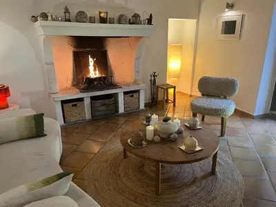 a bedroom with two beds and a fireplace at Suites de Bruoux in Gargas