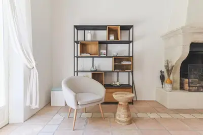 a living room with a chair and a fireplace at Villa Vue Luberon in Gordes