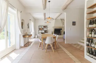 a kitchen and dining room with a table and chairs at Villa Vue Luberon in Gordes