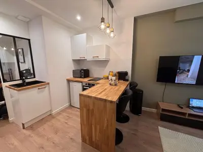 a kitchen with a wooden counter top in a room at Charmant appartement aixois in Aix-en-Provence