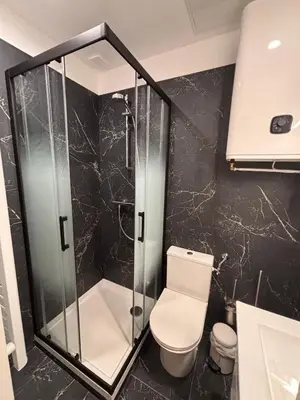 a bathroom with a toilet and a glass shower at Charmant appartement aixois in Aix-en-Provence