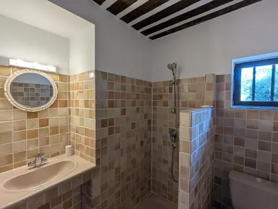a bathroom with a tub and a sink and a mirror at Mas traditionnel à Gordes en pleine nature in Gordes