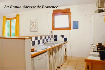 a kitchen with a sink and a refrigerator at La Bonne Adresse - Gite ZENITUDE in Cornillon-Confoux