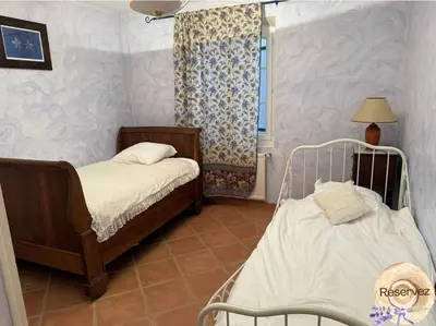 a bedroom with two beds and a window at Villa Provençale avec piscine in Pernes-les-Fontaines