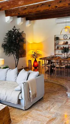 a living room with a couch and a table at Le Beldi, Mas de Village 1870 in Saint-Saturnin-lès-Avignon