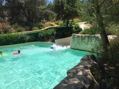 a person swimming in a swimming pool in a swimming pool at SUNRISE - Golf de Pont Royal in Mallemort