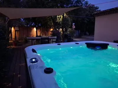 a swimming pool in a backyard at night at Logement indépendant avec Jacuzi pour 4ou 5 personnes, 2 chambres in Aureille
