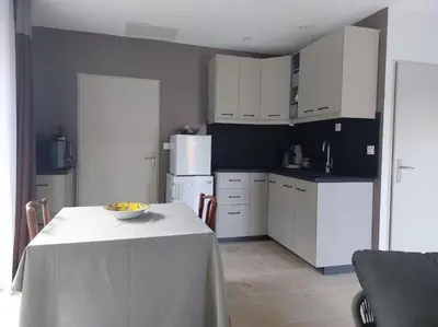 a kitchen with white cabinets and a table with a bowl on it at Logement indépendant avec Jacuzi pour 4ou 5 personnes, 2 chambres in Aureille