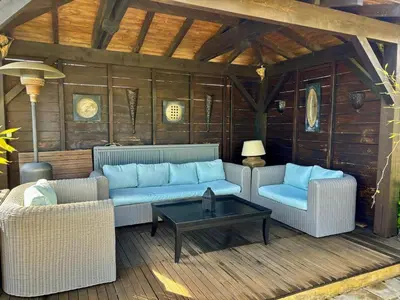a patio with two couches and a coffee table at Villa Aix-en-Provence Pool and absolute calm in Aix-en-Provence